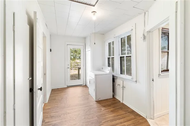 a view of hallway with wooden floor and window