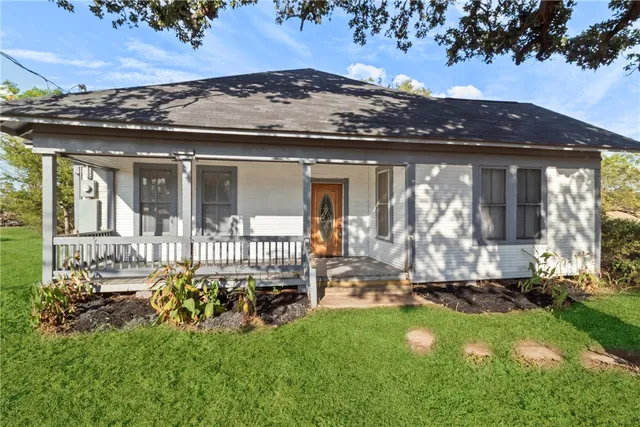 a view of a house with backyard porch and sitting area
