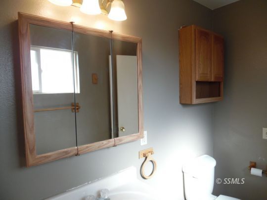1612 South Yorktown Street Ridgecrest, CA 93555 - Photo 20 of 26 a bathroom with a mirror and a shower