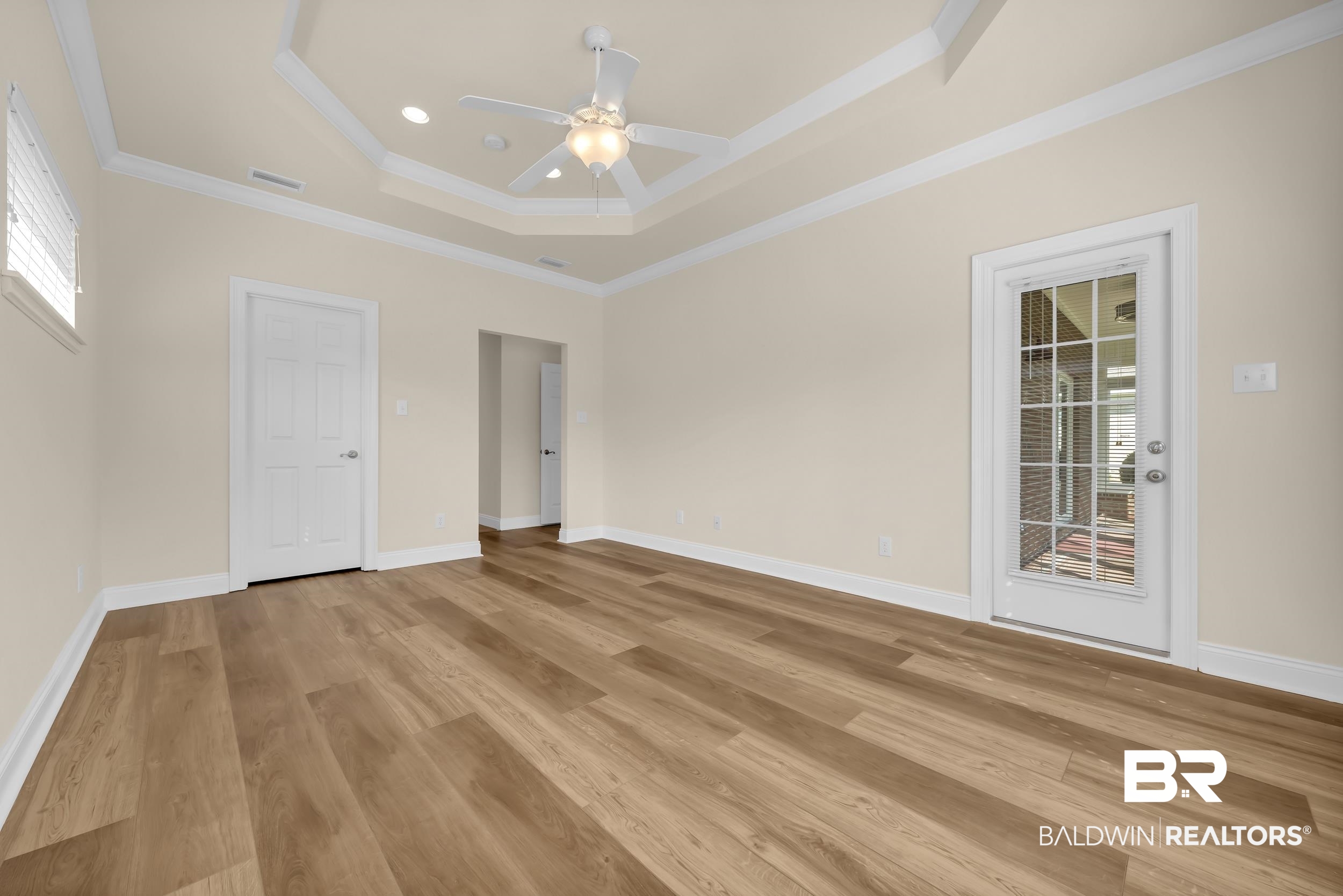 226 Hemingway Loop Foley, AL 36535 - Photo 16 of 53 Unfurnished bedroom featuring a raised ceiling, ceiling fan, ornamental molding, light wood-style flooring, and recessed lighting