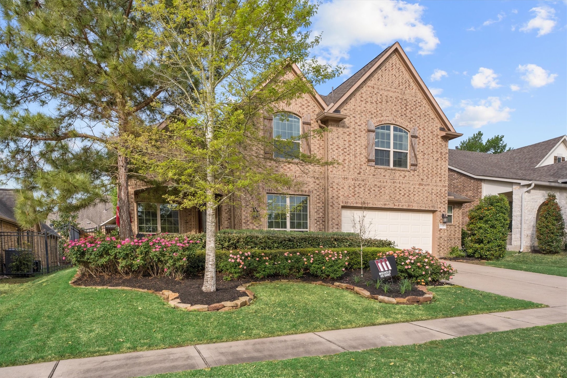 27121 Holtwood Grove Road Magnolia, TX 77354 - Photo 2 of 50 Stunning Curb Appeal! This beautifully landscaped home welcomes you with a spacious front patio—perfect for relaxing and enjoying the neighborhood. The lush greenery and charming design make a lasting first impression!