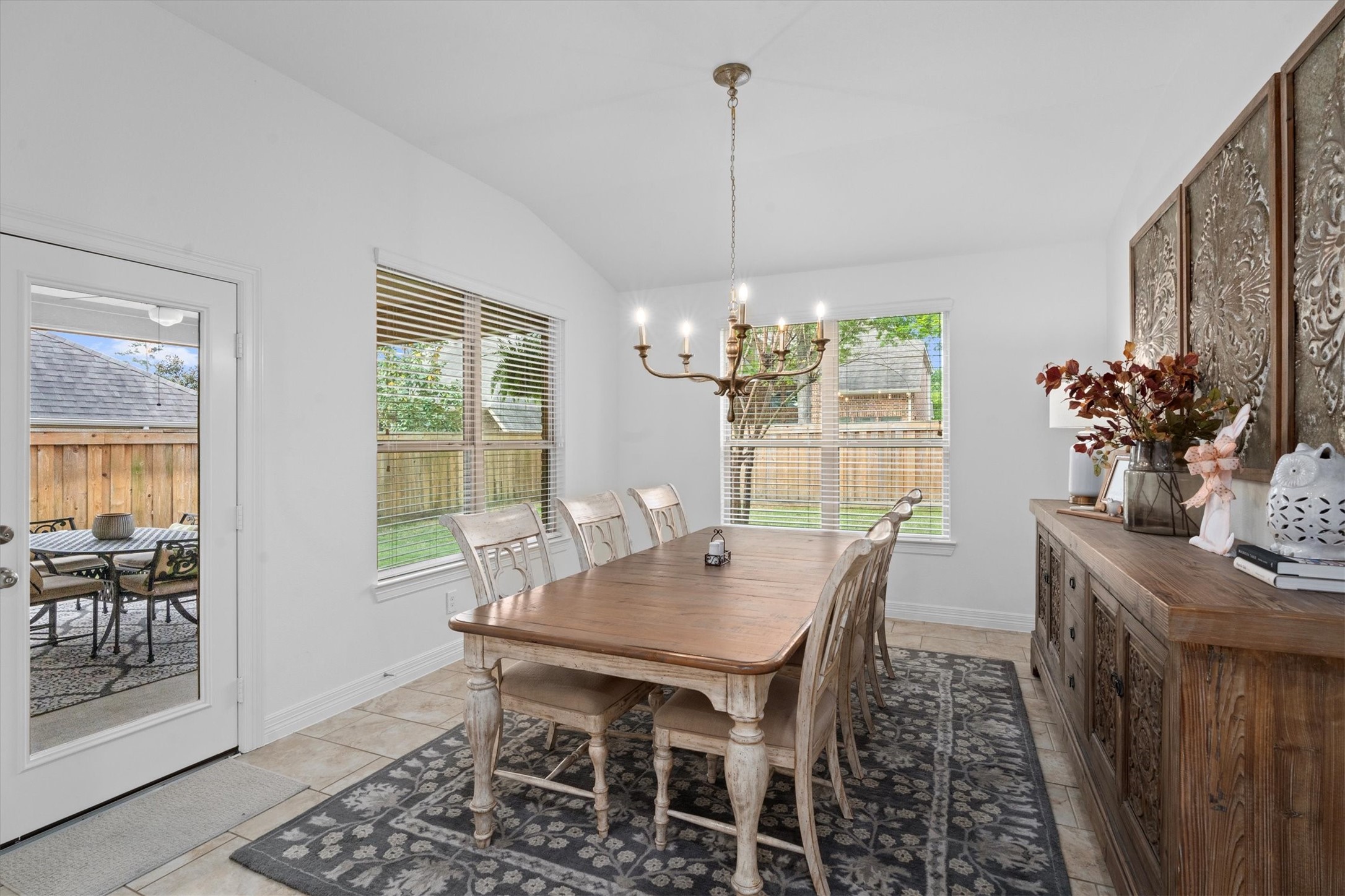 27121 Holtwood Grove Road Magnolia, TX 77354 - Photo 22 of 50 Just off the kitchen, the expansive breakfast room offers an impressive amount of space – perfect for casual dining or morning coffee. The room is beautifully accented by a statement chandelier, adding a touch of elegance to this bright and welcoming area.