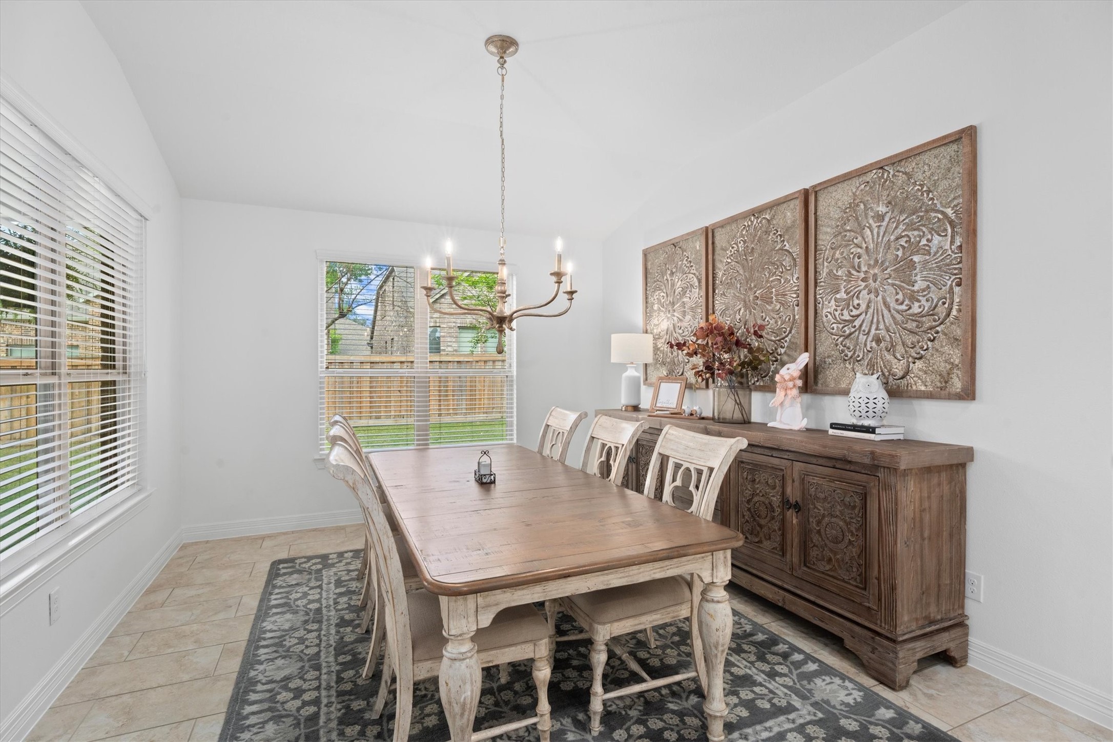 27121 Holtwood Grove Road Magnolia, TX 77354 - Photo 24 of 50 Just off the kitchen, the expansive breakfast room offers an impressive amount of space – perfect for casual dining or morning coffee. The room is beautifully accented by a statement chandelier, adding a touch of elegance to this bright and welcoming area.