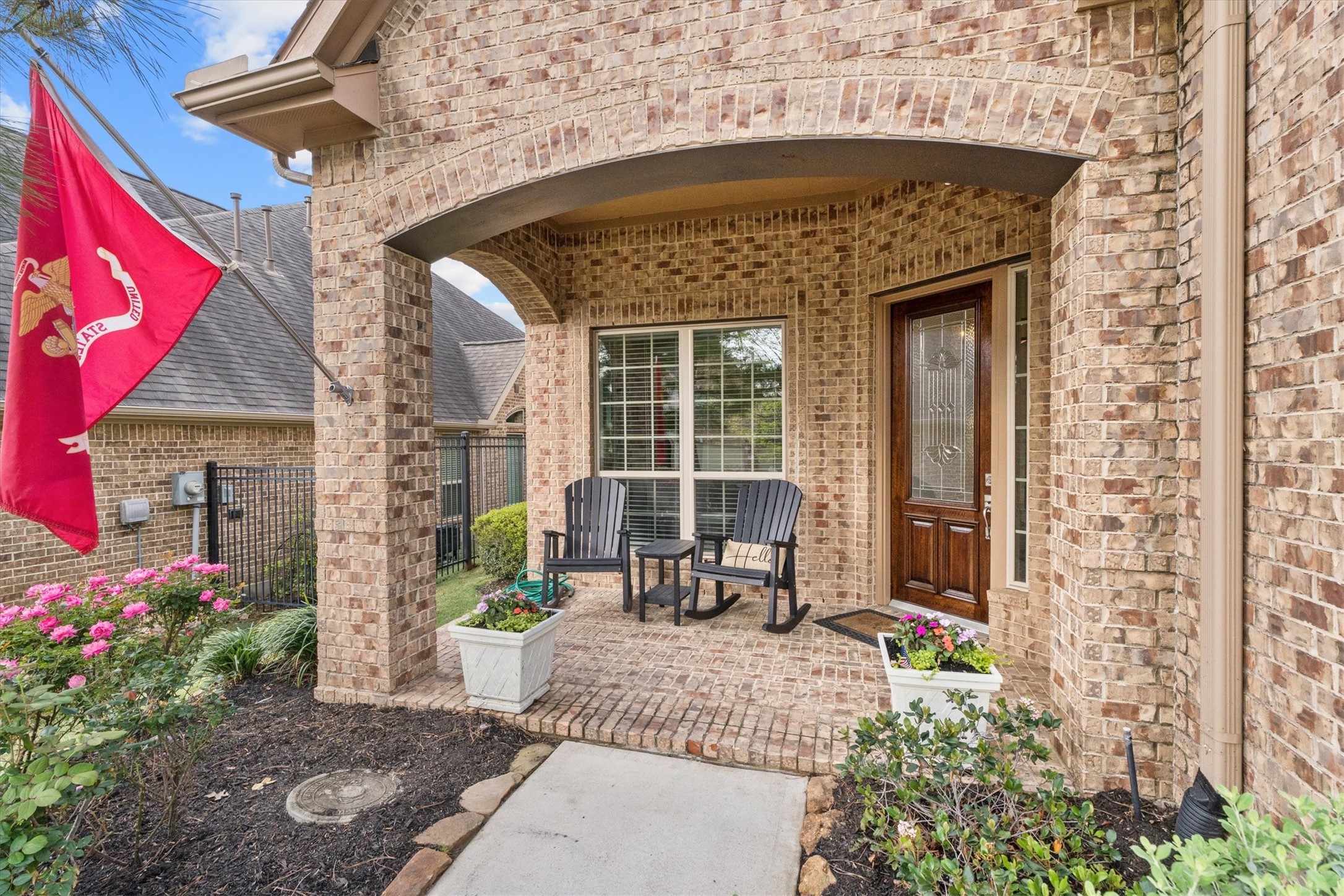 27121 Holtwood Grove Road Magnolia, TX 77354 - Photo 3 of 50 This spacious front patio offers a warm welcome with a cozy sitting area, perfect for morning coffee or evening relaxation. The freshly stained front door adds a touch of elegance, complementing the inviting atmosphere of this beautiful home.