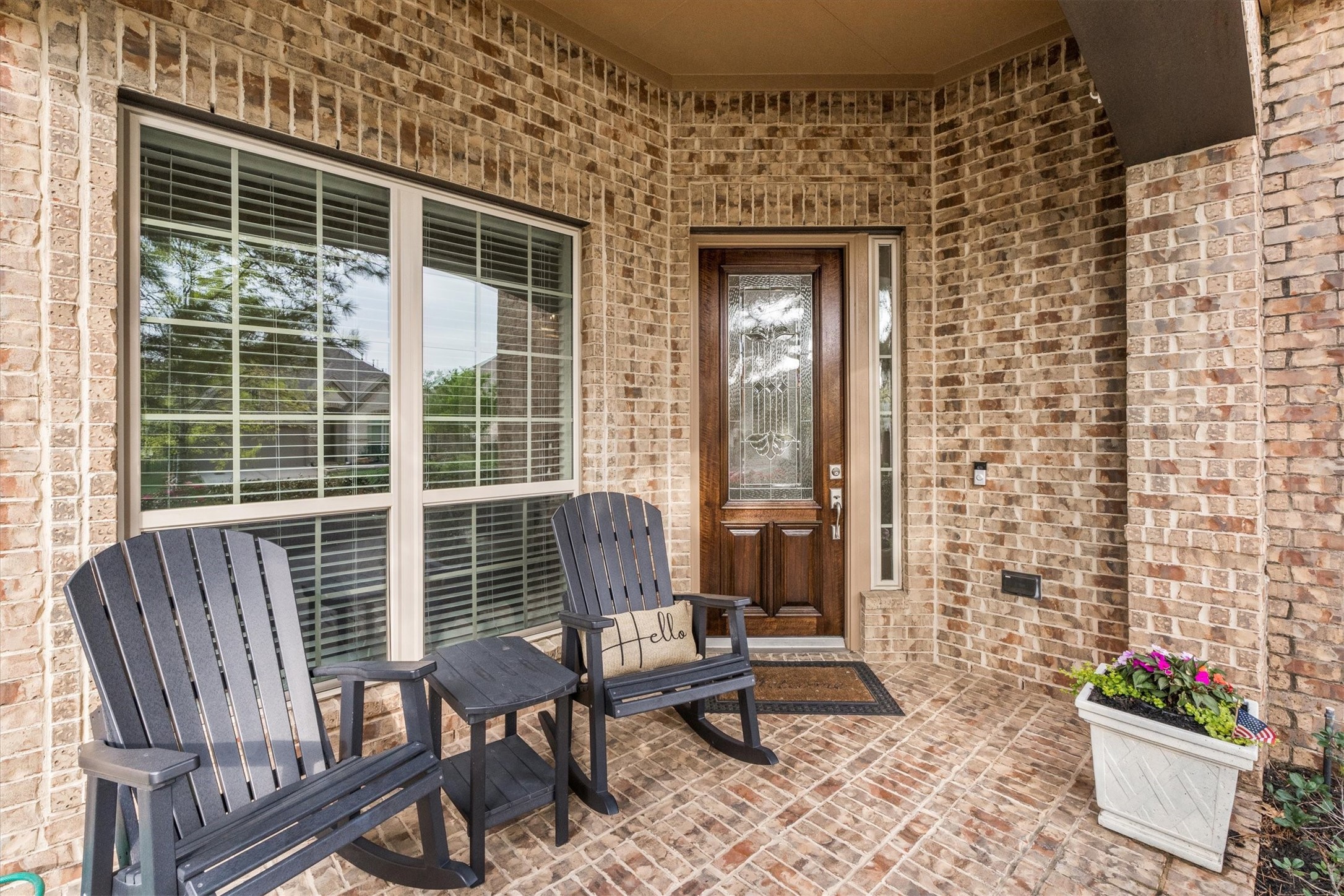 27121 Holtwood Grove Road Magnolia, TX 77354 - Photo 4 of 50 This spacious front patio offers a warm welcome with a cozy sitting area, perfect for morning coffee or evening relaxation. The freshly stained front door adds a touch of elegance, complementing the inviting atmosphere of this beautiful home.