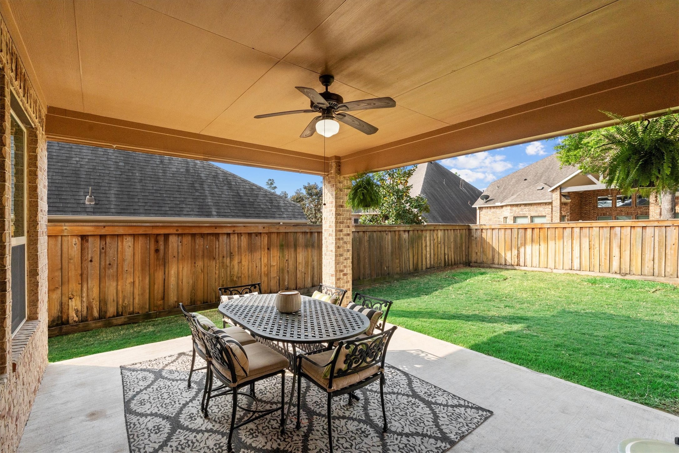 27121 Holtwood Grove Road Magnolia, TX 77354 - Photo 45 of 50 The extended back patio offers ample space to unwind, entertain, or enjoy outdoor dining. Whether you’re grilling, relaxing, or hosting gatherings, this versatile area adapts to suit your lifestyle, creating the perfect outdoor retreat.