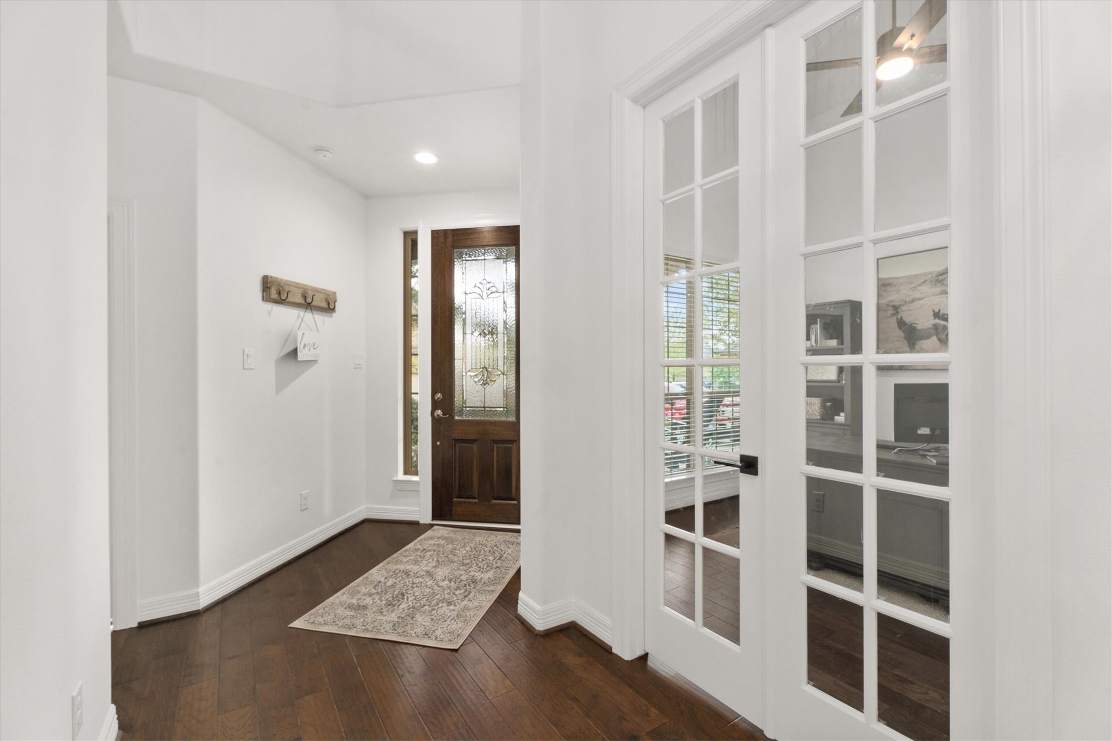 27121 Holtwood Grove Road Magnolia, TX 77354 - Photo 6 of 50 Just off the entry, this bright and airy office features soaring ceilings, beautiful French doors, and plenty of natural light. The perfect space for productivity, creativity, or a quiet retreat!