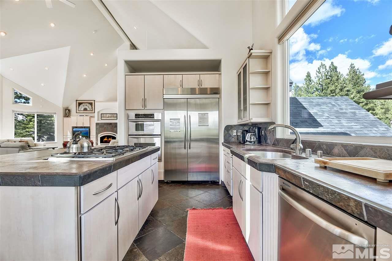 230 Chimney Rock Road Stateline, NV 89449 - Photo 8 of 25 a kitchen with stainless steel appliances granite countertop a sink stove and cabinets