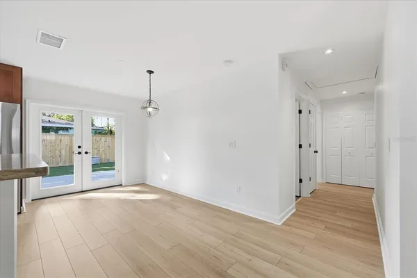 a view of a room with wooden floor and white walls