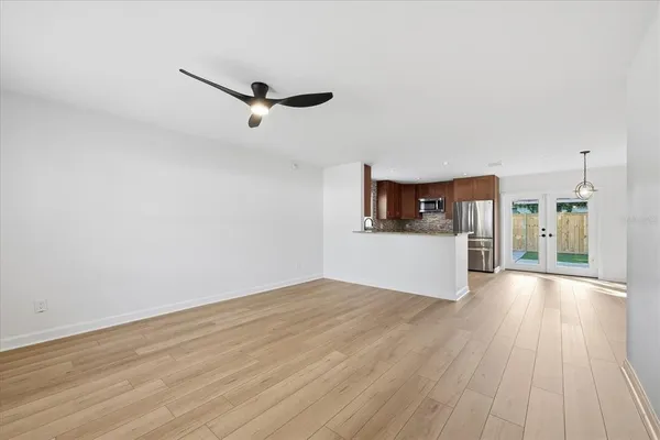 a view of a kitchen with wooden floor and a sink