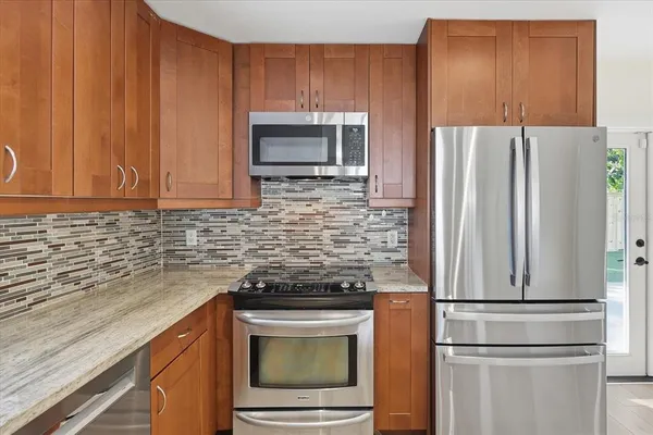 a kitchen with a refrigerator stove and microwave