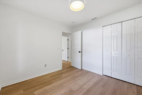 a view of a room with wooden floor