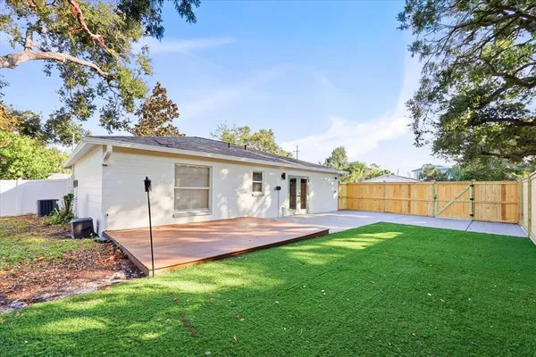 a view of a house with a yard and a patio