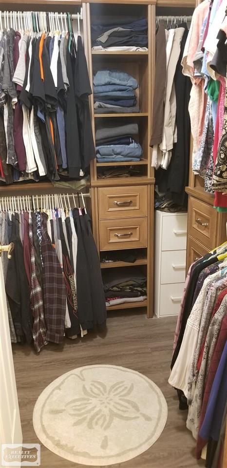 13124 Burgess Road Memphis, MI 48041 - Photo 22 of 55 Master bedroom walk-in closet with custom organized shelving.