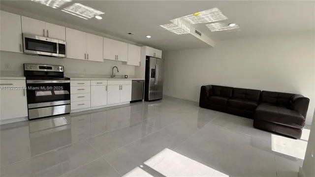 a kitchen with a sink stainless steel appliances and cabinets