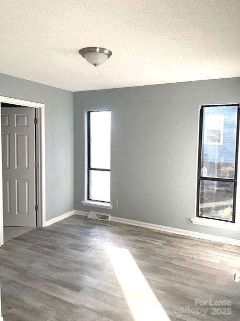 11112 5 Cedars Road Charlotte, NC 28226 - Photo 24 of 25 a view of an empty room with wooden floor and a window