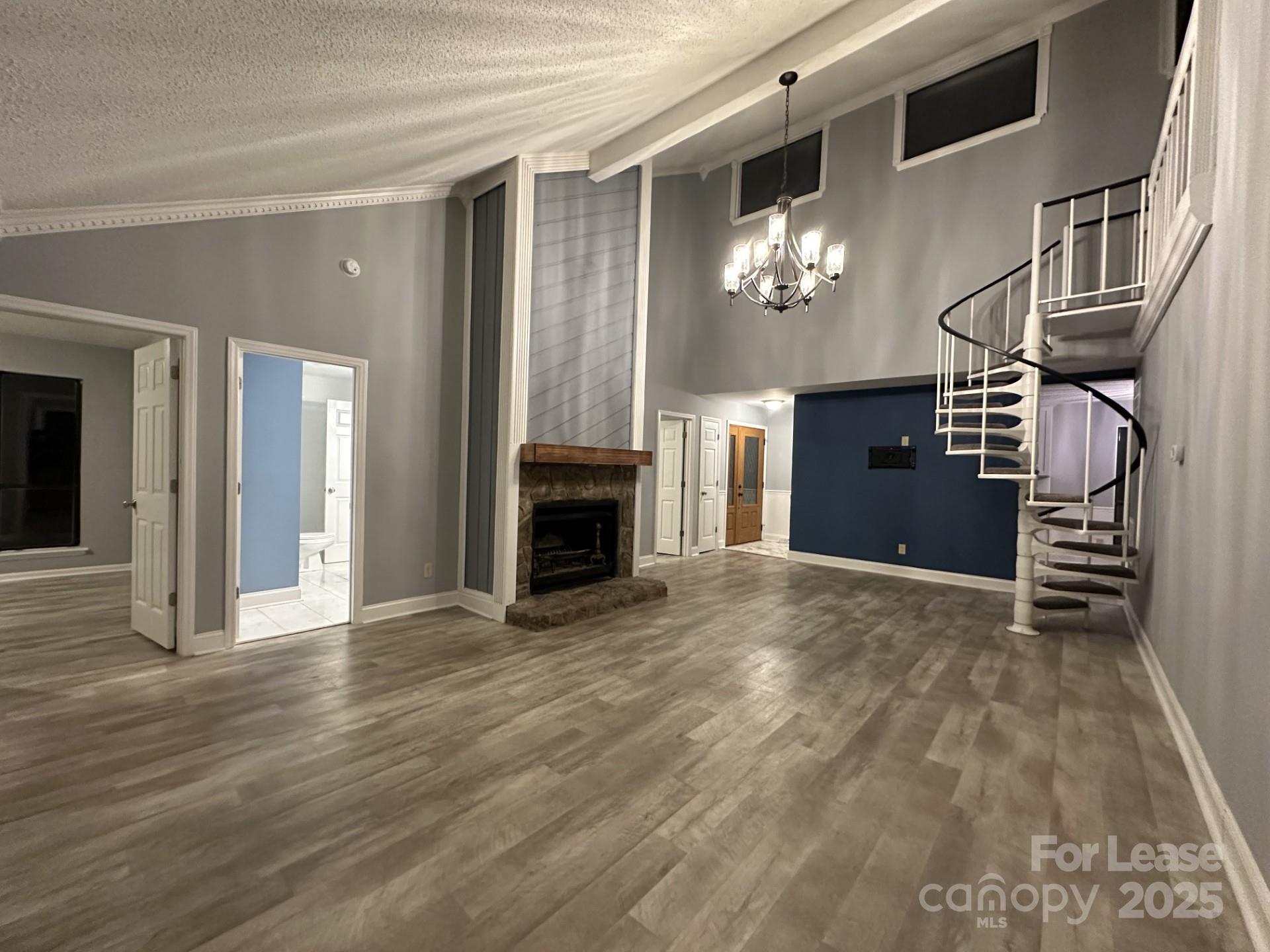 11112 5 Cedars Road Charlotte, NC 28226 - Photo 3 of 25 a view of an empty room with kitchen and fire place
