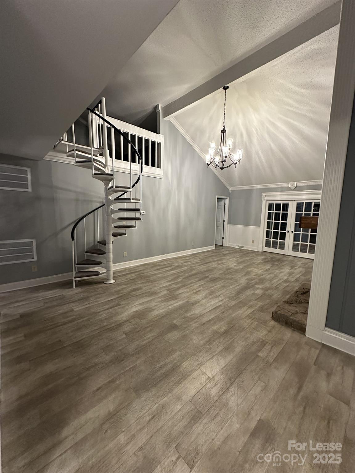 11112 5 Cedars Road Charlotte, NC 28226 - Photo 4 of 25 an empty room with wooden floor and windows