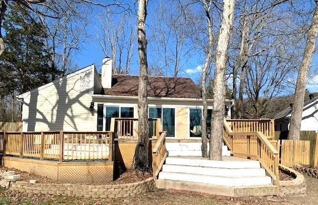 a view of a house with large windows and a small yard