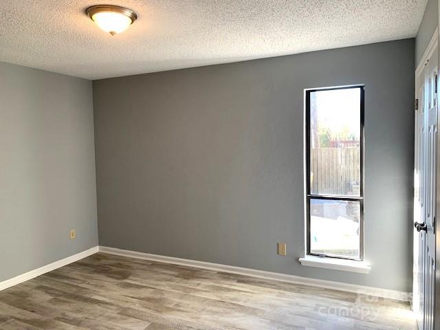 11112 5 Cedars Road Charlotte, NC 28226 - Photo 9 of 25 an empty room with wooden floor and windows