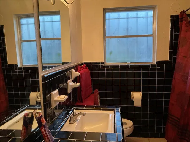 a bathroom with pair of shower