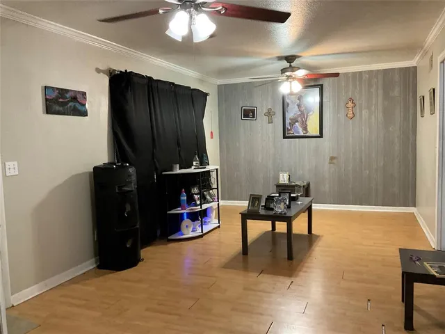 a living room with furniture a piano and a flat screen tv