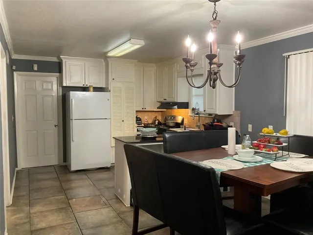 a kitchen with a refrigerator a kitchen island a stove and a refrigerator