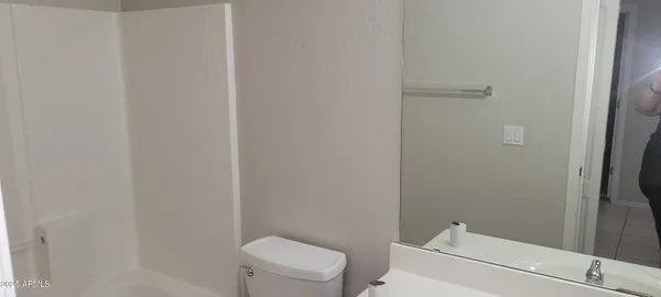 a front view of a building and trees