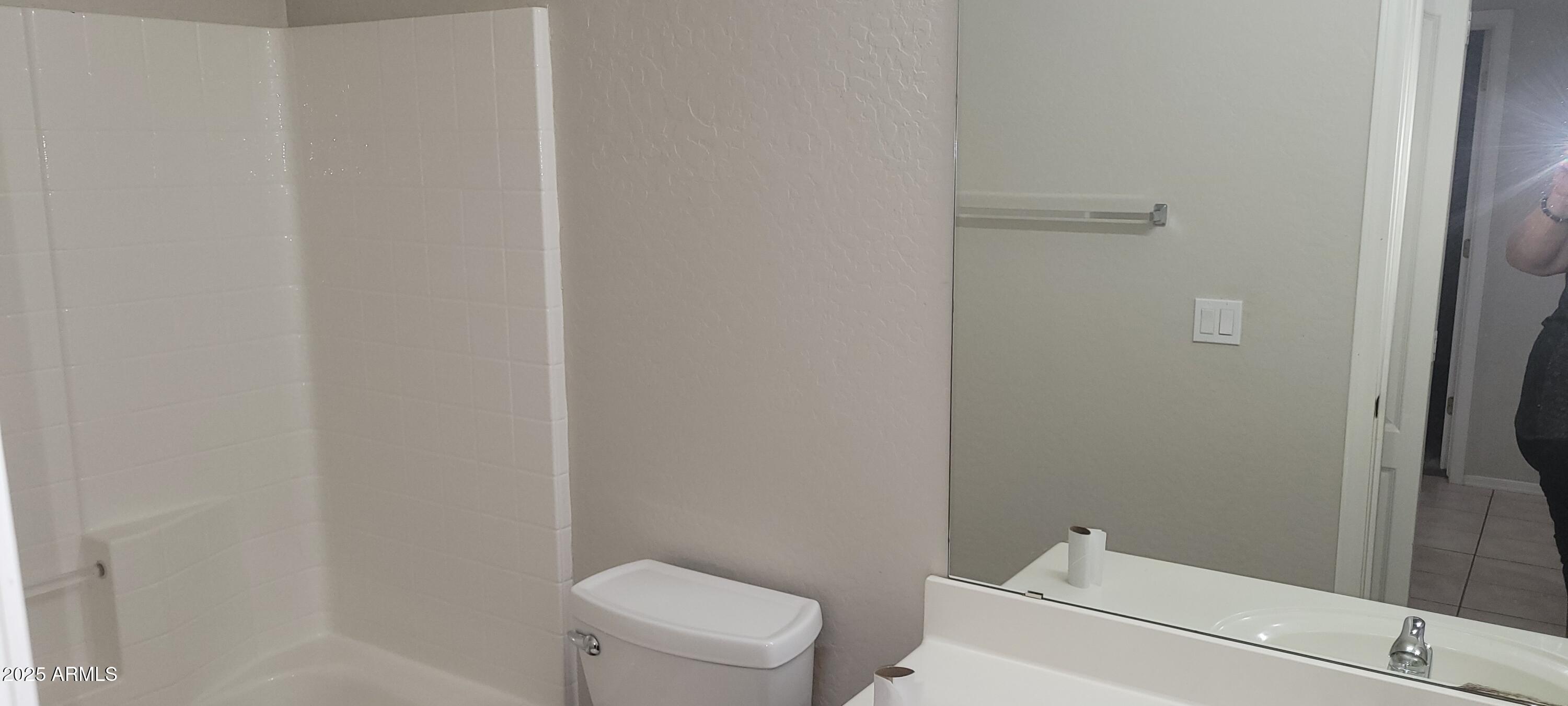 2600 East Springfield Place, Unit 108 Chandler, AZ 85286 - Photo 11 of 13 a white toilet sitting next to a shower