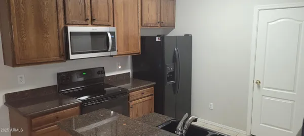 a kitchen with appliances and cabinets