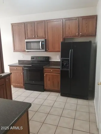 a kitchen with a sink a stove and cabinets