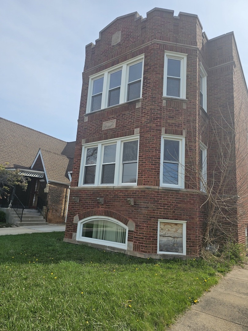 9439 South Racine Avenue Chicago, IL 60620 - Photo 2 of 11 a front view of a house with a yard