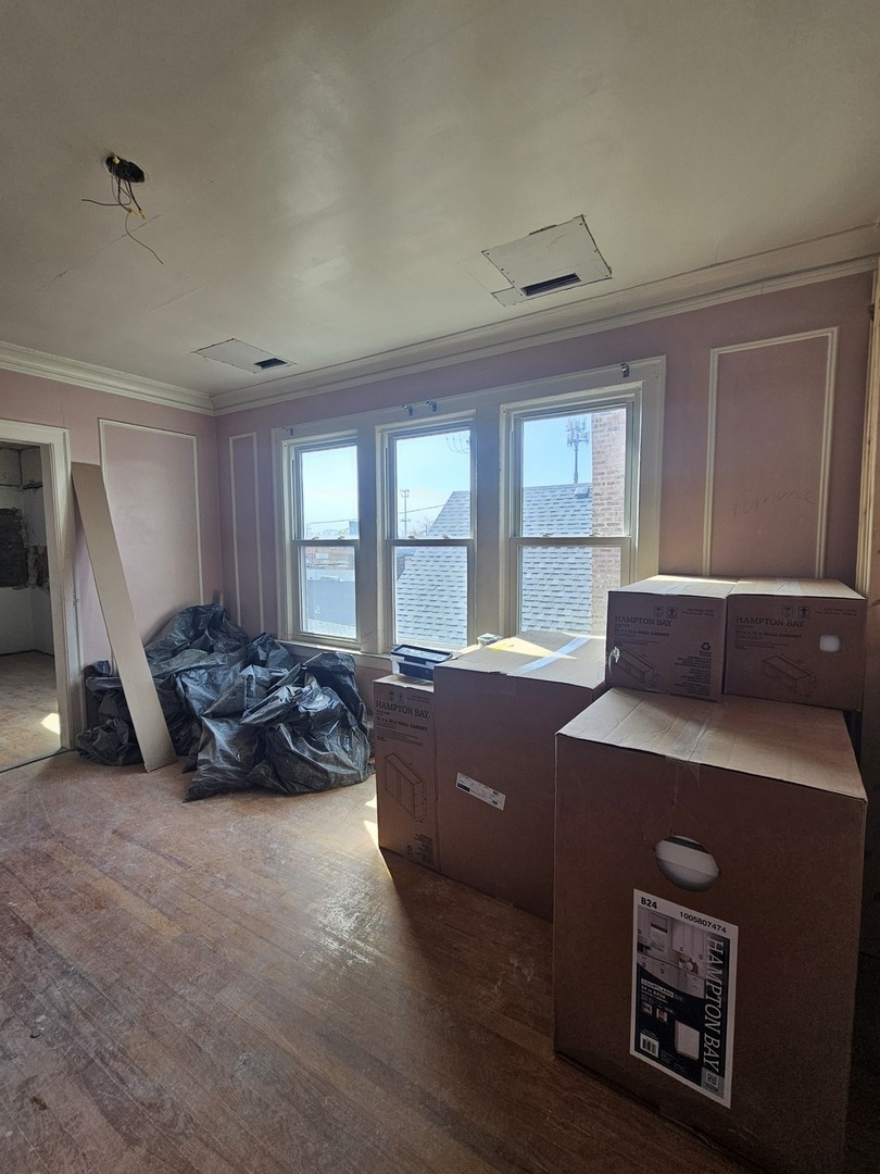 9439 South Racine Avenue Chicago, IL 60620 - Photo 7 of 11 a large room with a bed and a window