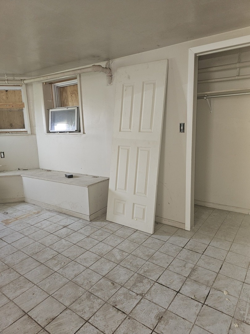 9439 South Racine Avenue Chicago, IL 60620 - Photo 10 of 11 a living room with a baby crib furniture and a window