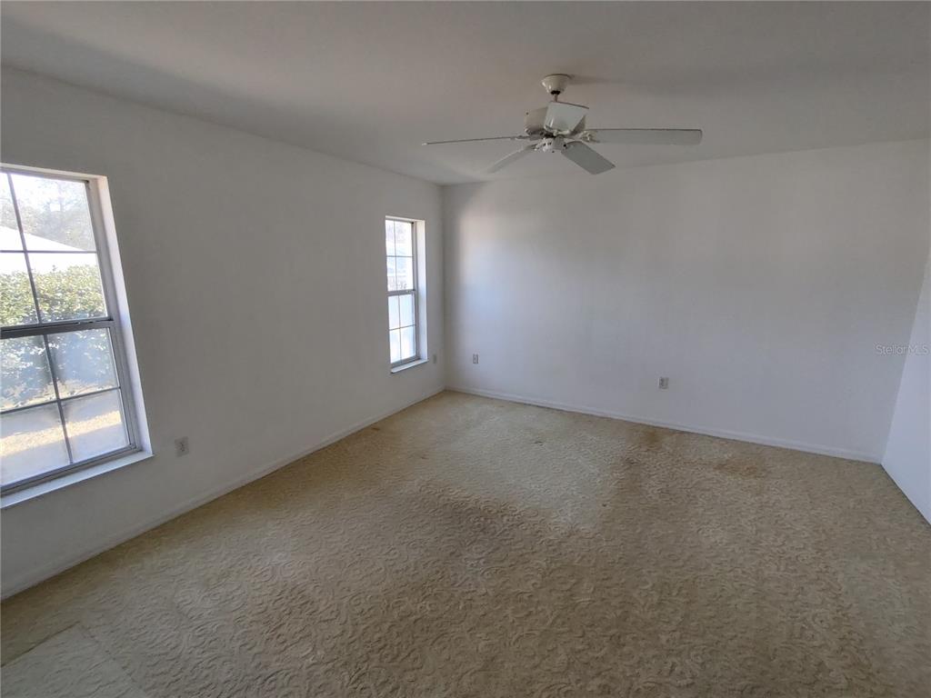 7257 Southwest 115th Place Ocala, FL 34476 - Photo 11 of 18 an empty room with windows and closet