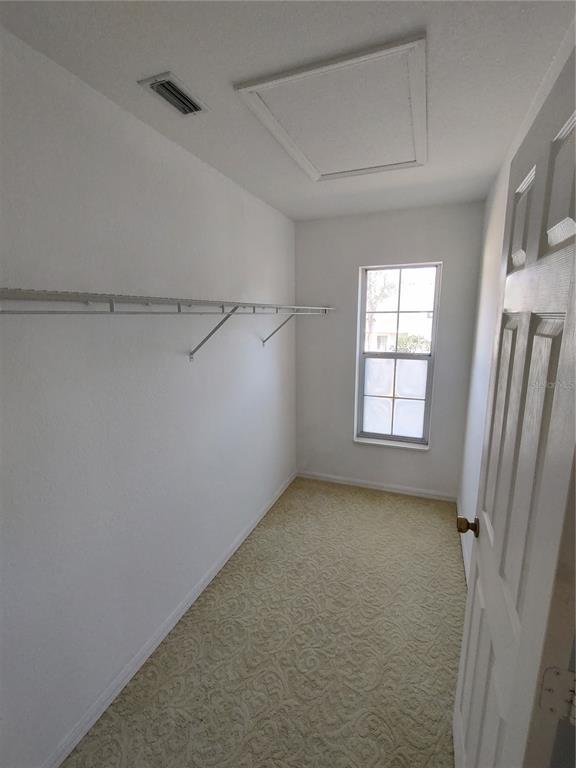 7257 Southwest 115th Place Ocala, FL 34476 - Photo 12 of 18 wooden floor in an empty room with a window