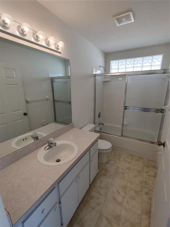 7257 Southwest 115th Place Ocala, FL 34476 - Photo 16 of 18 a bathroom with a sink a toilet and shower