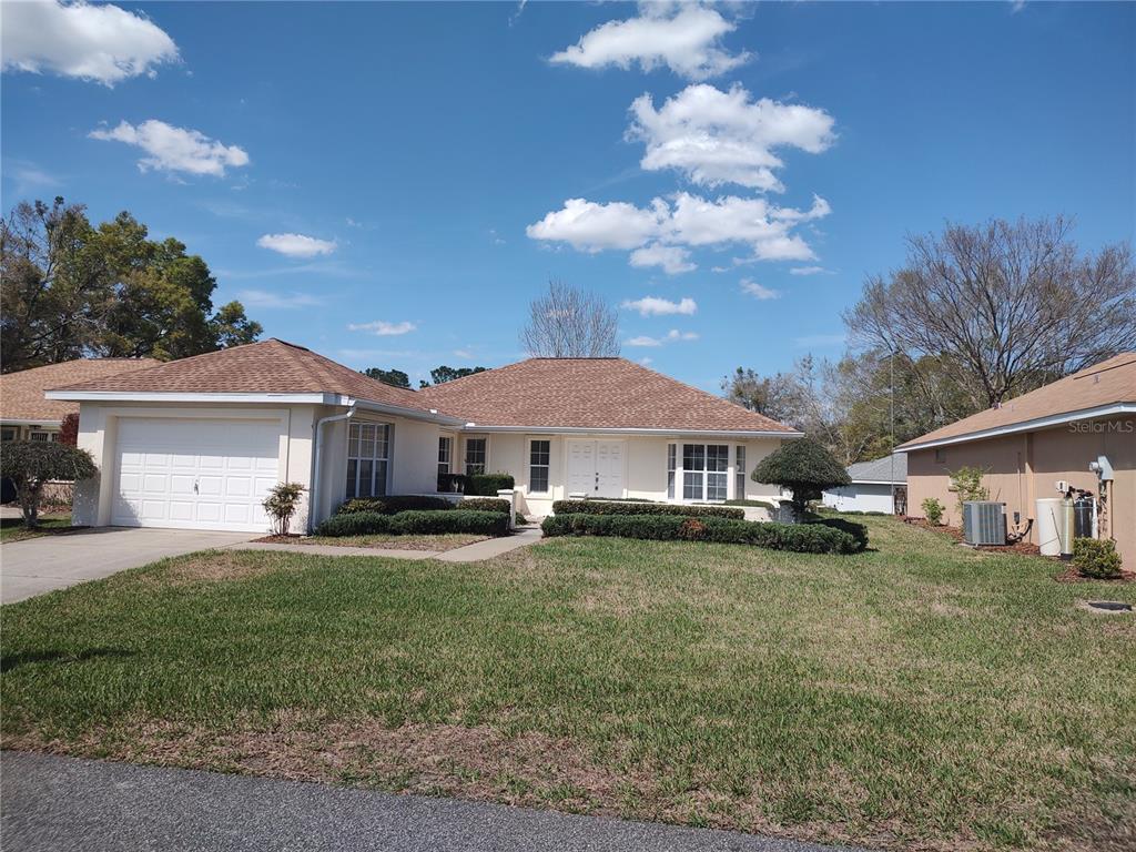 7257 Southwest 115th Place Ocala, FL 34476 - Photo 2 of 18 a view of a house with a yard