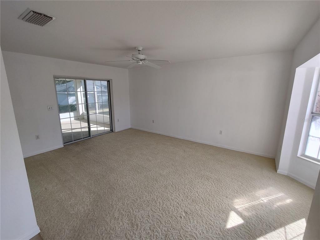 7257 Southwest 115th Place Ocala, FL 34476 - Photo 5 of 18 an empty room with windows