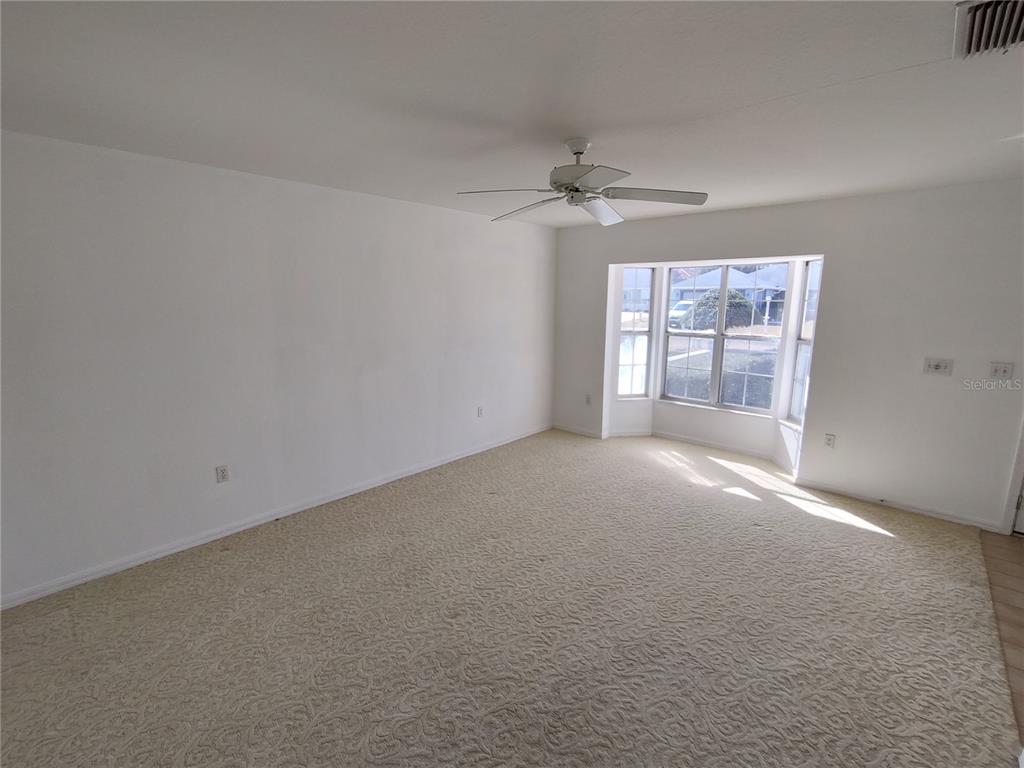 7257 Southwest 115th Place Ocala, FL 34476 - Photo 6 of 18 a view of empty room with windows