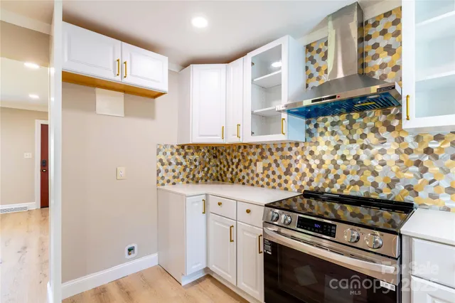 a kitchen with stainless steel appliances granite countertop a stove and a sink