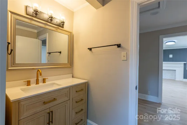 an empty room with wooden floor windows and fan