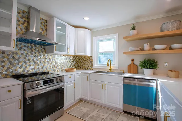 a kitchen with white cabinets and appliances