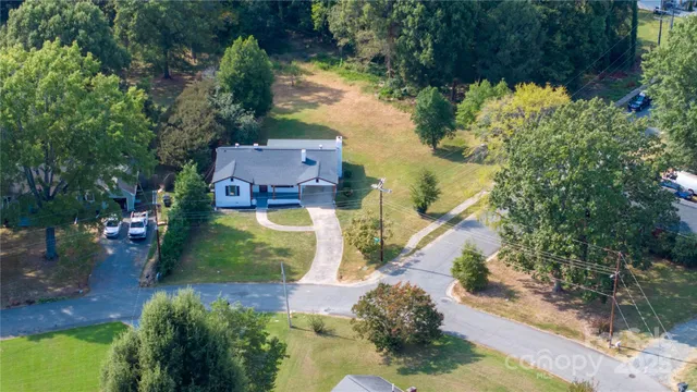 an aerial view of house with yard swimming pool and outdoor seating