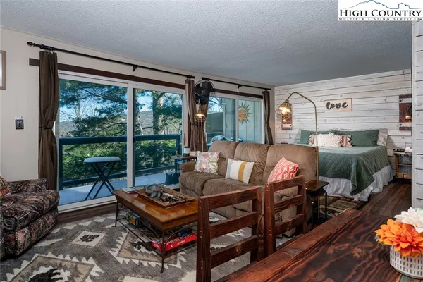 a living room with furniture and a floor to ceiling window