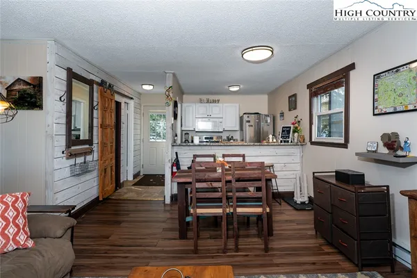 a view of a dining room with furniture and a kitchen