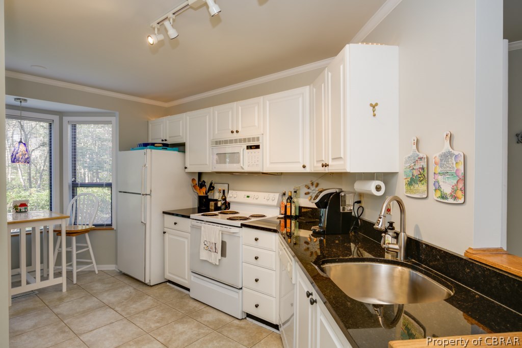 63 Mariners Point Lane, Unit A Hartfield, VA 23071 - Photo 9 of 29 Eat-in Kitchen boasts a large pantry, built-in microwave, electric range, stainless sink, disposal and refrigerator.