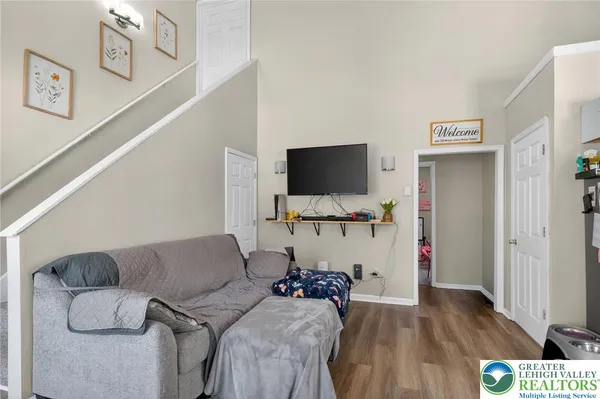 a living room with furniture and a flat screen tv