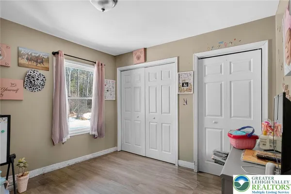 a view of a livingroom with wooden floor and a window