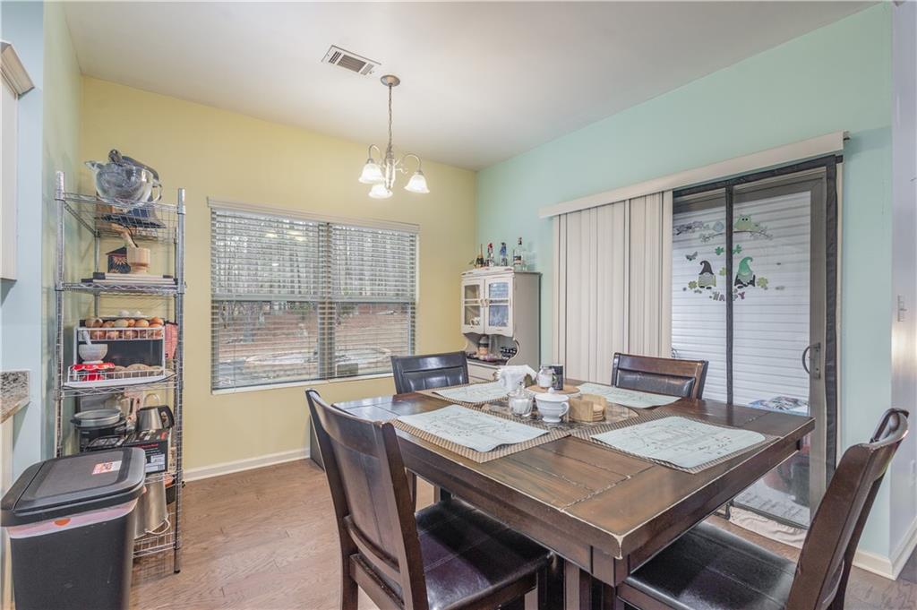 21 Sunny Point Newnan, GA 30263 - Photo 11 of 33 a view of a dining room with furniture large windows and wooden floor